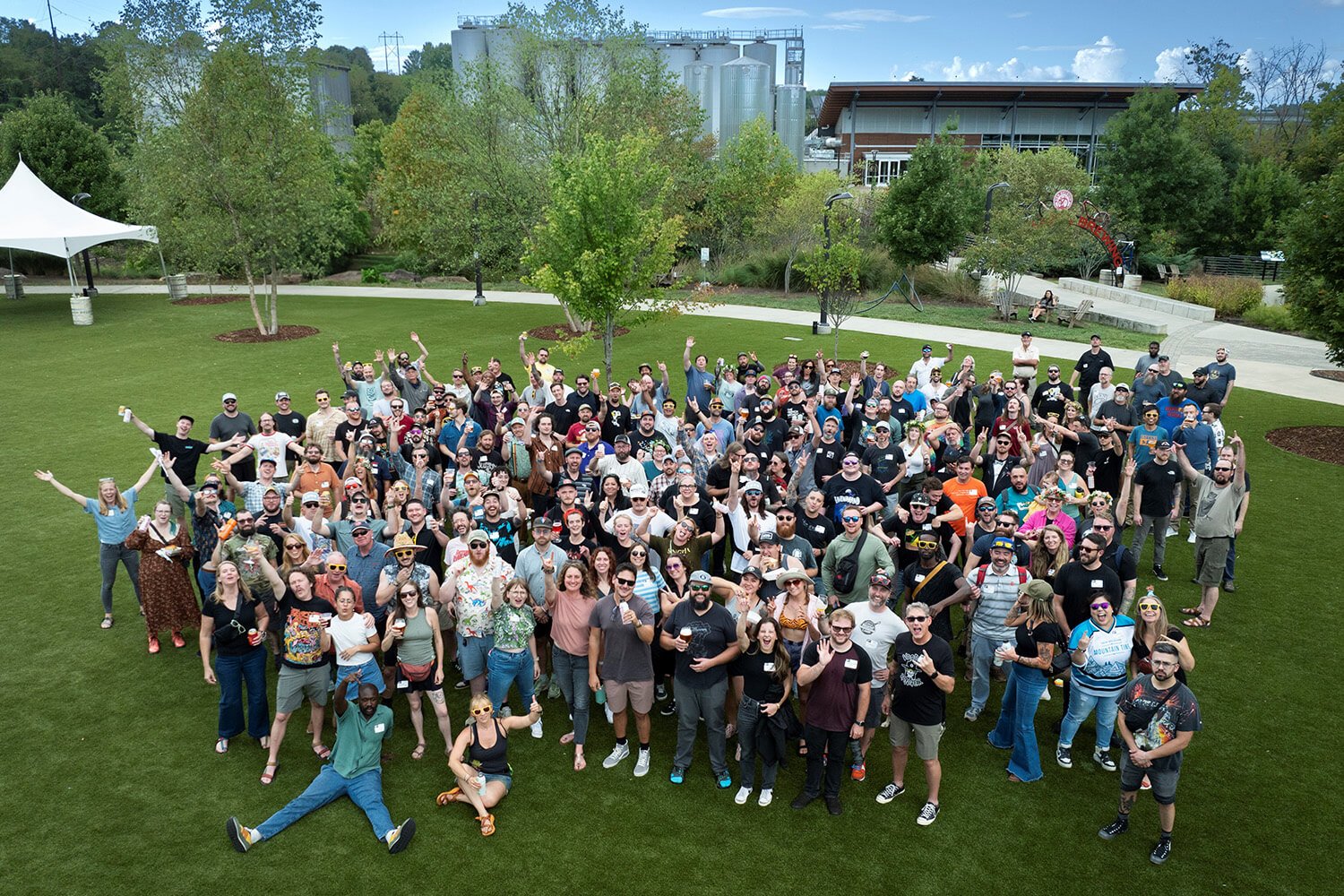 Coworkers pose for a group photo after the 2024 State of the Business meeting in Asheville, NC